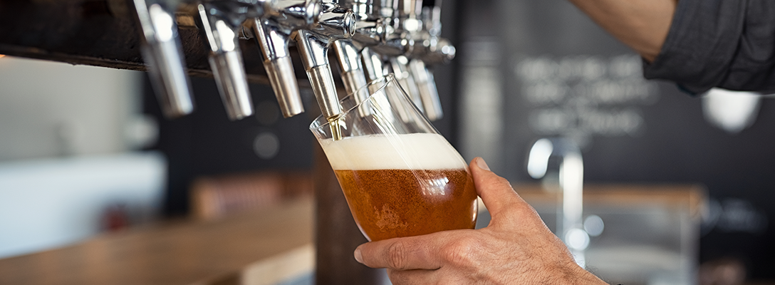 Bartender Pouring Beer from Tap for National Beer Day