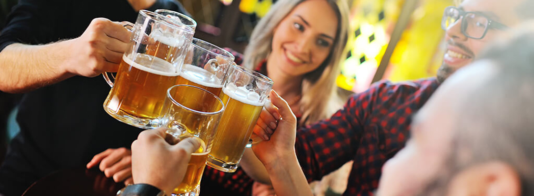 Group of friends cheersing with their beer 