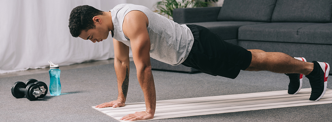 Man Doing Plank Exercise in Hotel Room