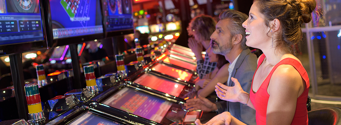 People Playing at Row of Las Vegas Slot Machines