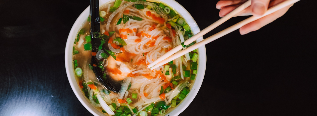 Person Eating Phở Las Vegas Noodle Dish