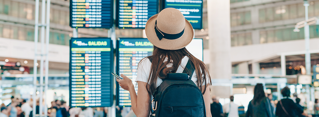 Person in Airport Checking Departing Flights to Vegas