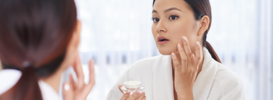 Woman Applying Sunscreen to Face