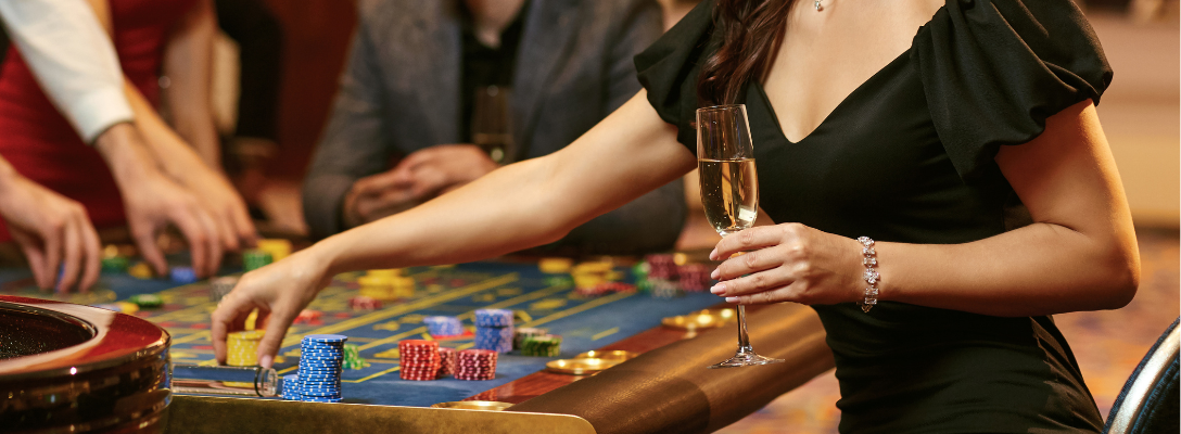 Woman Drinking Free Casino Drink at Table Game