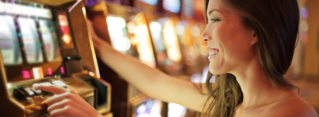 Woman Using Slot Machine to Learn How to Gamble in Vegas